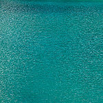 Turquoise water surface with gentle waves - View 1